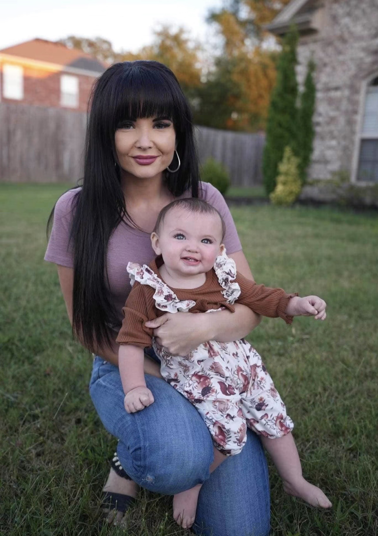 Legacy Homes co-owner holding her daughter in the backyard