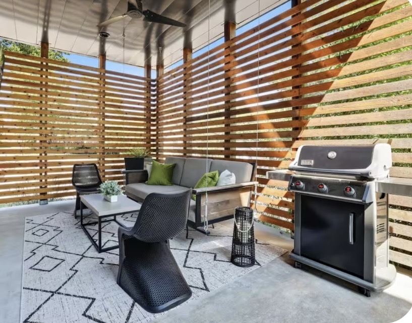 Covered patio enclosed with horizontal cedar slat privacy walls