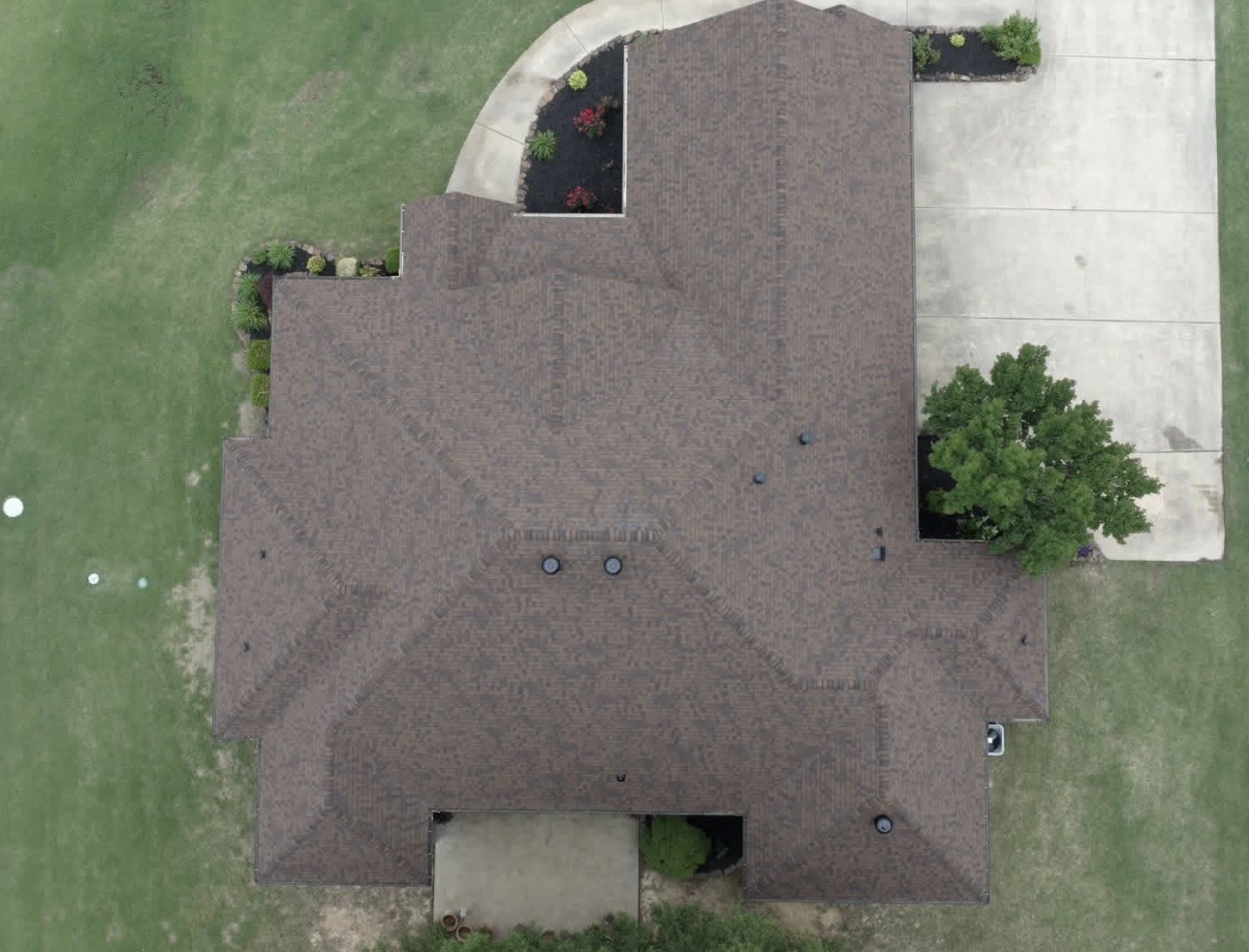 Aerial view of a completed brown architectural shingle roof