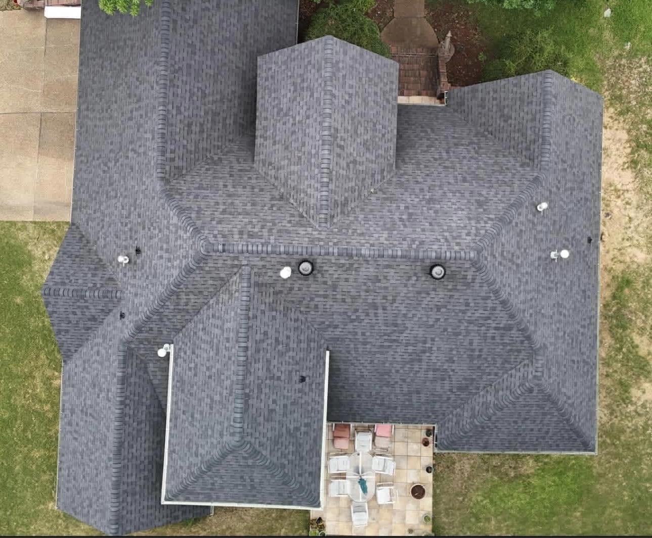 Aerial view of a completed gray shingle roof replacement