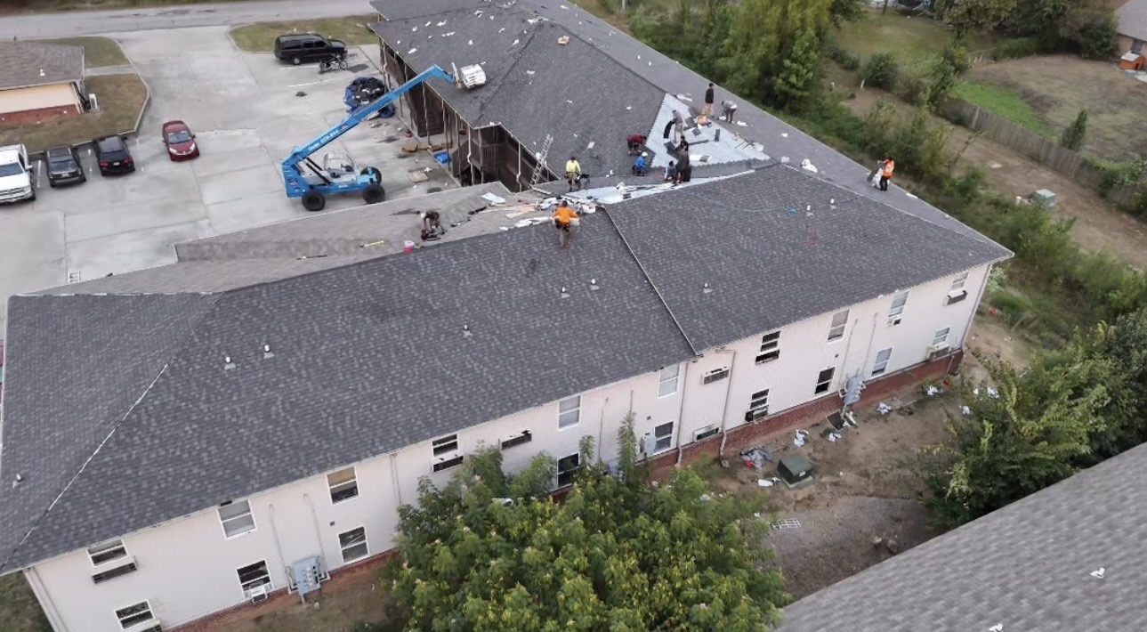 Crew replacing the roof on a multi-family apartment building