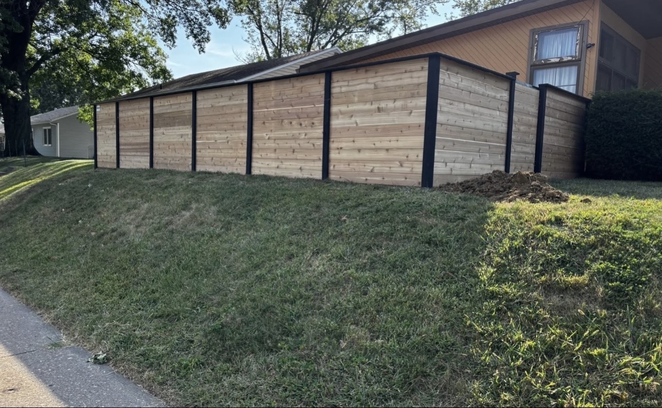 Modern horizontal cedar privacy fence with black steel posts